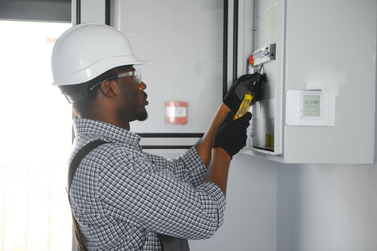 man working on an electrical board, switchgear and electrical material business
